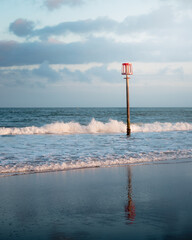 Beach groynes in the wet sand at Sandown beach, Isle of Wight