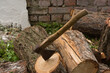 columnar sawn firewood and an ax stuck in them