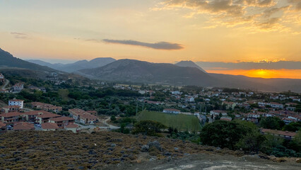 Wall Mural - Gökceada, Imbros Island city center at sunset with buildings, Zeytinlikoy village, volcanic mountains view