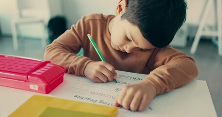 Wall Mural - Boy child, education and student writing in classroom with learning, knowledge and academic growth. Activity, studying and lesson, paper with test and letters, alphabet at school with development