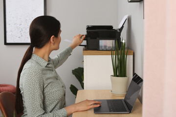 Poster - Woman using modern printer at workplace indoors