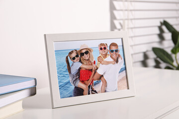 Canvas Print - Frame with family photo on white table indoors, closeup