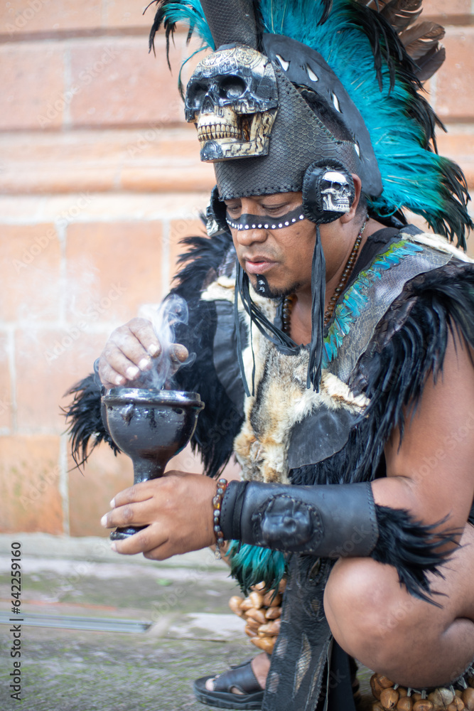 Aztec Ritual Impersonators close up of a concentrated shaman smelling smoke from a calyx or ritual ...