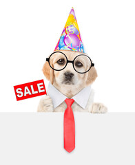 Poster - Golden retriever puppy wearing necktie party cap shows signboard with labeled 