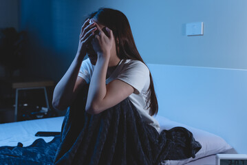 Insomnia at night concept, Selective focus at the  time in alarm clock and the person covering her face because can not sleep as background