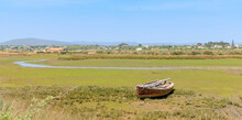 Beautiful Landscape With Abandonned Fishing Boat In Portugal