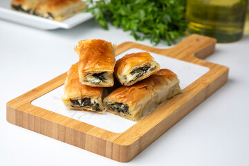 Wall Mural - Handmade Spinach Cheese Pie - pastry, Turkish name; el acmasi borek, rulo borek. Turkish borek rolls with spinach and cheese. A traditional Turkish pastry rulo borek