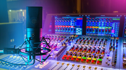 Wall Mural - Professional microphone. DJ mixing console. Sound recording equipment. Condenser microphone on tripod. Podcast recording equipment. Audio technologies. DJ workplace. Selective focus