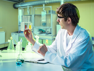 Poster - laboratory technician. man with medical test tubes. laboratory assistant in white coat. medical scie