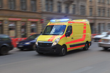 Wall Mural - ambulance is driving along a city street.