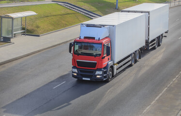 Poster - Truck with a trailer moves along the city street