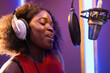 © ADDICTIVE STOCK - Black woman singing and creating song