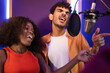 © ADDICTIVE STOCK - Man and black woman singing and recording song together