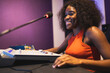© ADDICTIVE STOCK - Happy black woman recording sound