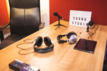 Sound Studio Room With Empty Chair And Table With Tablet Headphones Microphones In Light