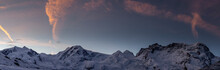 Snowy Mountains In Winter Day Under Dark Blue Sky At Sunrise