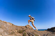 © sutulastock - tourist girl with a backpack on her back climbs the mountain in summer