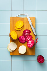 Wall Mural - Sliced beets of different colors on a cutting board, white, yellow, purple.