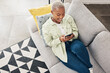 © Chanelle Malambo/peopleimages.com - Woman, relax and typing with phone on sofa for social media, chat and online contact at home from above. Happy african person, smartphone and download mobile games, digital multimedia and dating app