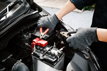Close-up Hand Auto Mechanic Using Connect Jumper Cables On Terminal Dead Battery For Jump-start Or Check Car Battery Fail Problem To Change Repairing And Fix Car And Maintenance Servicing.