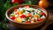 Colorful and refreshing Mediterranean couscous salad with vegetables and feta cheese