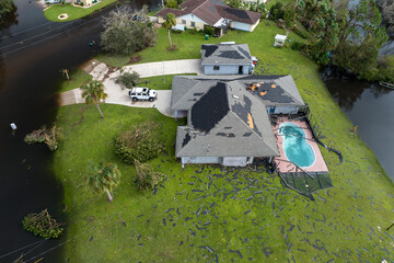 Canvas Print - Hurricane destroyed house with damaged roof and lanai enclosure over swimming pool in Florida residential area. Consequences of natural disaster