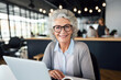 © Nikki AI - Portrait of a Senior Woman in Glasses Working or Studying on Laptop in a Cafe and Looking at the Camera