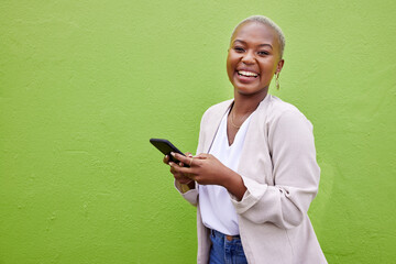 Poster - Black woman, smile and phone for portrait by a wall or green background with internet. African female person laughing with smartphone for social media, networking and communication or chat app space