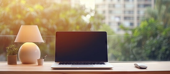 Poster - Blurred office background with a wooden desk laptop wireless mouse graphics tablet and notebook