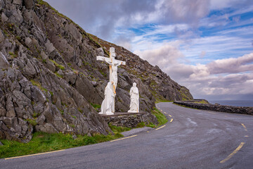 White crucifixion statues at the rocky mountain by the scenic road on the shore