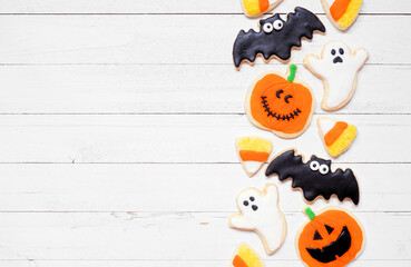 Canvas Print - Halloween cookie side border. Overhead view on a white wood background with copy space. Ghosts, bats, jack o lanterns and candy corn.