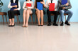 © Pixel-Shot - Young people with clipboards waiting for job interview in room
