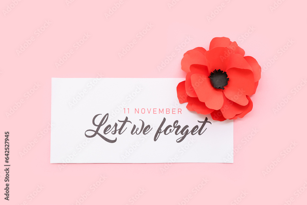 Red poppy flower with card on pink background. Remembrance Day in Canada