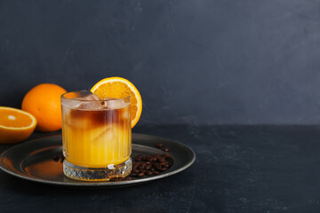 Wall Mural - Glass of cold orange espresso on black background