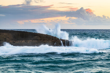 Wall Mural - Wave breaking at sunset