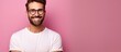 Brunette man with beard poses happily camera in focus on pink background