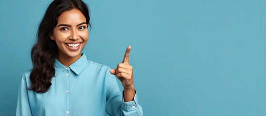 Confident young Hispanic woman pointing in different directions over blue background for an advertisement