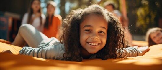 Aufkleber - A biracial schoolgirl reading a book in the school playground with copy space representing education childhood inclusivity and learning