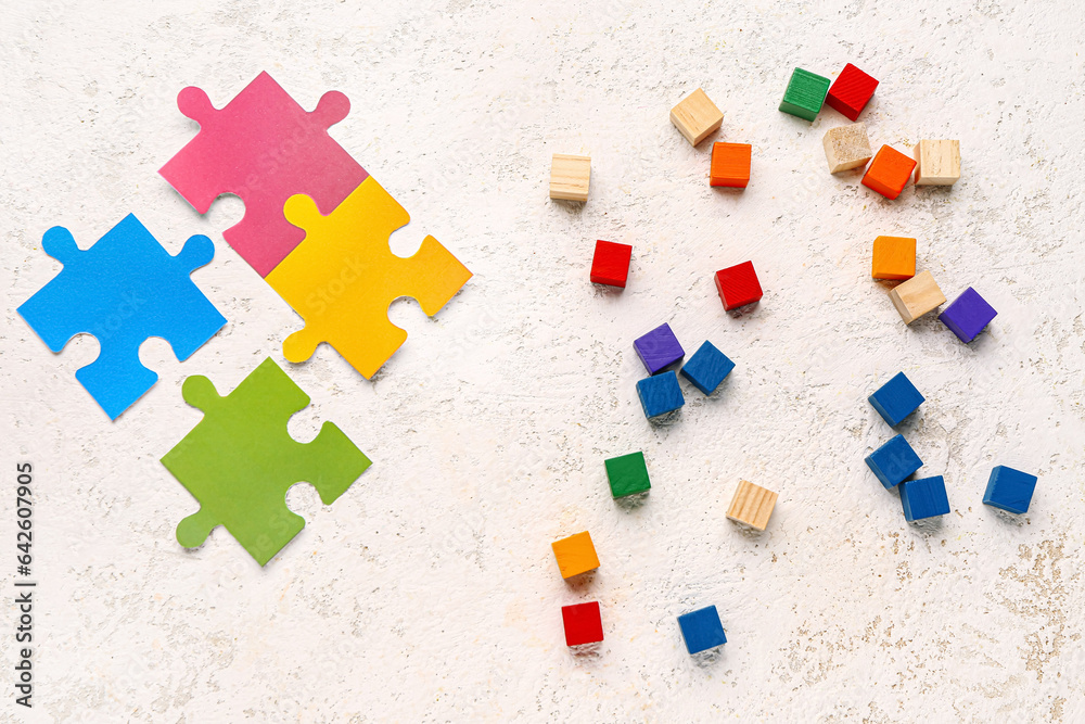 Frame made of puzzle pieces and cubes on grunge background. Logic concept