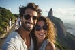 © Anne Schaum - Couple in their 30s smiling near the Christ the Redeemer in Rio de Janeiro Brazil