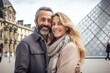 © Anne Schaum - Couple in their 40s smiling at the Louvre Museum in Paris France