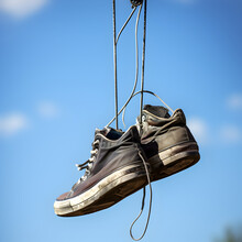 Shoes Hanging From A Telephone Wire As Sometimes Found In Residential And Urban Neighborhoods In The City. Generative Ai. 