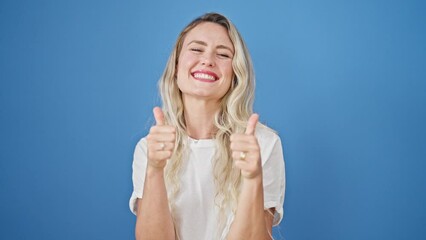 Sticker - Young blonde woman smiling with thumbs up over isolated blue background