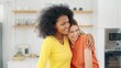 © M Stocker - Happy lesbian woman couple enjoy talking and spending time together in kitchen room at home. Lesbian couple love moment. lgbt rights. Lesbian couple concept