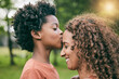 © Charlize Davids/peopleimages.com - Boy, kiss mother and forehead in park, smile or profile for love, care or bonding to relax in sunshine. African mom, child and happy in garden, backyard and countryside for smile, summer and holiday