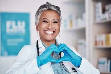 Poster - Senior, happy woman and portrait of doctor with heart sign for healthcare, service or love at hospital. Mature female person or medical professional smile in happiness, like emoji or hands at clinic