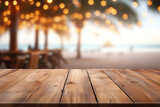 Fototapeta  - Wooden table and blur beach cafes background with bokeh lights. High quality photo
