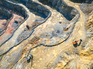 Opencast Mine Aerial View. Industrial terraces in a mining quarry. Open pit mining of dolomite. Excavation machinery of the dolomite mine. Extractive industry. Opencast mining.