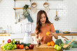 © Art_Photo - Portrait of beauty healthy asian woman making orange fruit smoothie with blender.girl preparing cooking detox cleanse with fresh orange juice in kitchen at home.health, vitamin c, diet, healthy drink