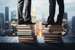 Close up of businessman and businesswomans feet on books, cityscape, success concept